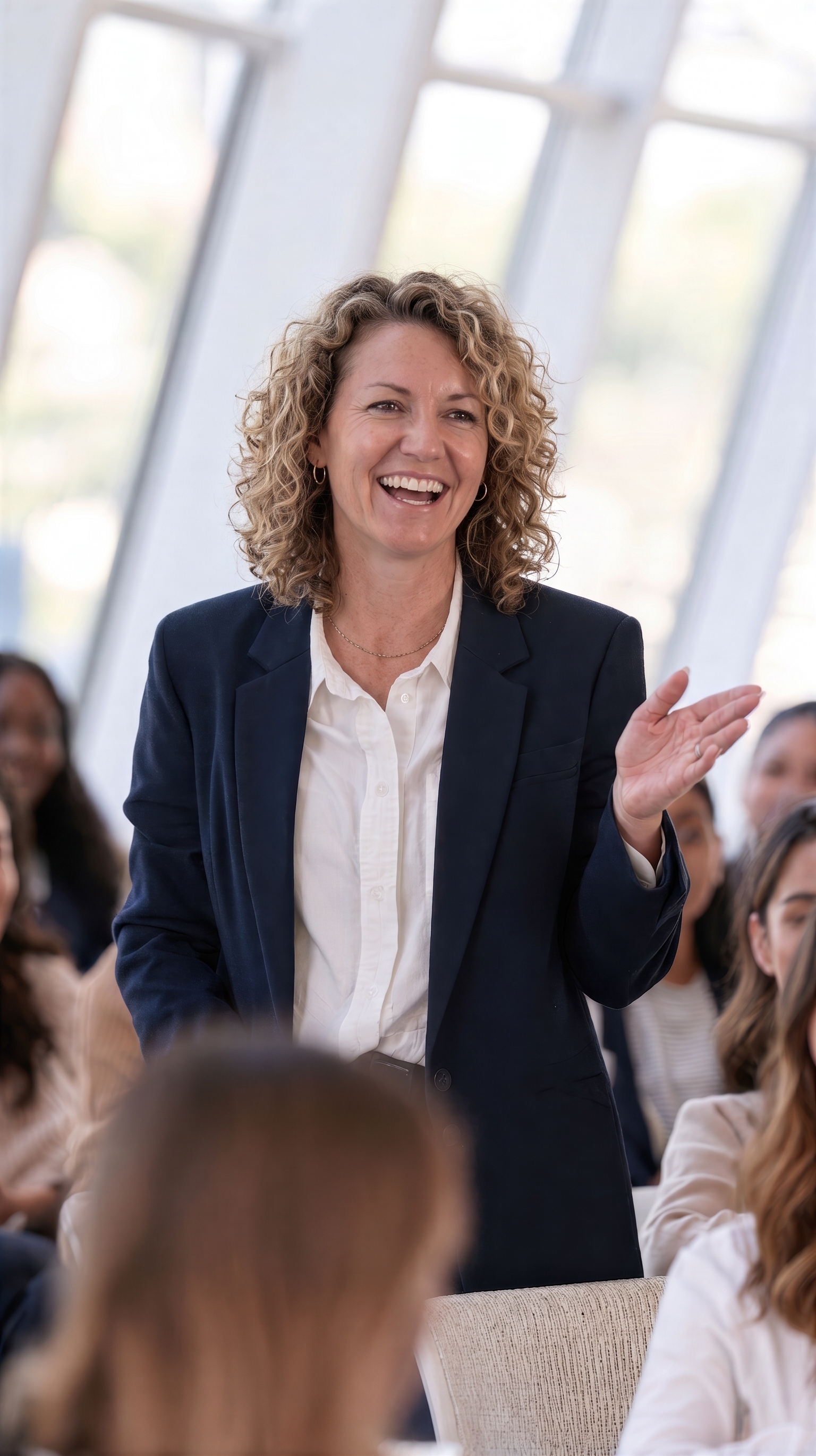 A leader speaking warmly with a group during a training session